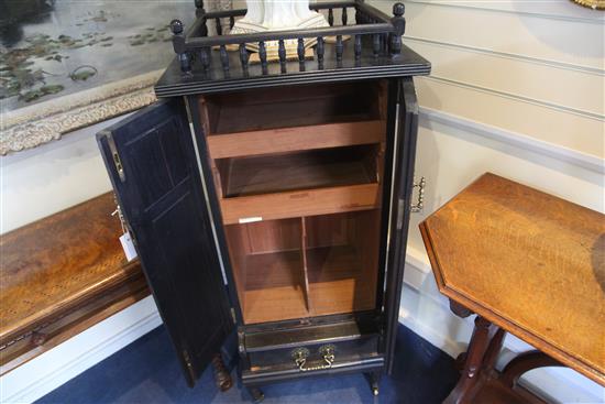 An Aesthetic movement ebonised music cabinet, in the manner of Morris & Co., W.30in.